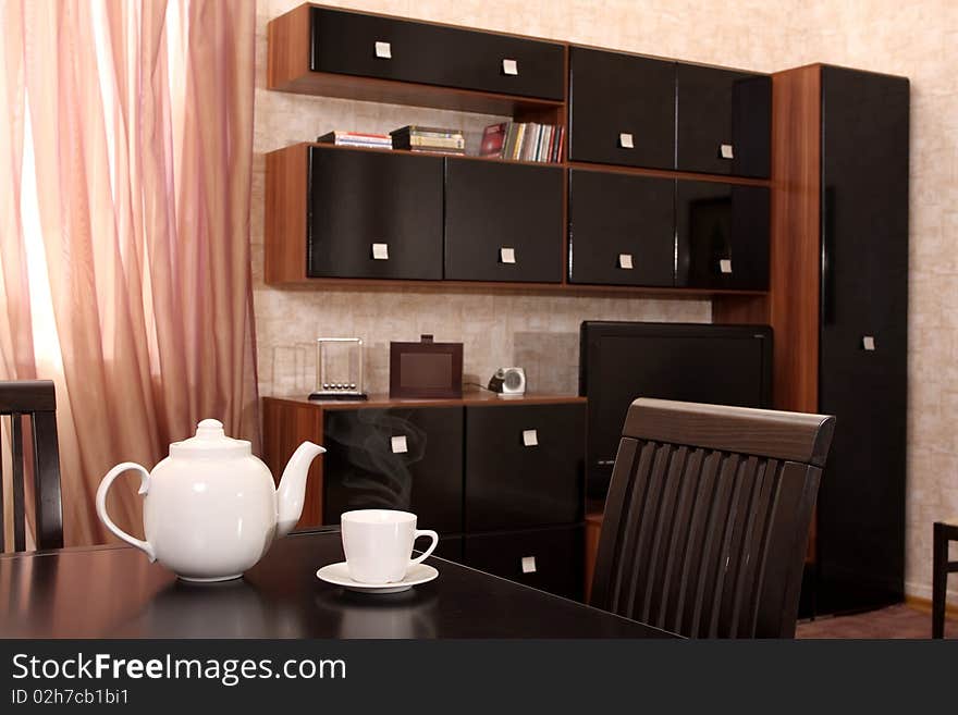 Interior of a living room with a window and different furniture