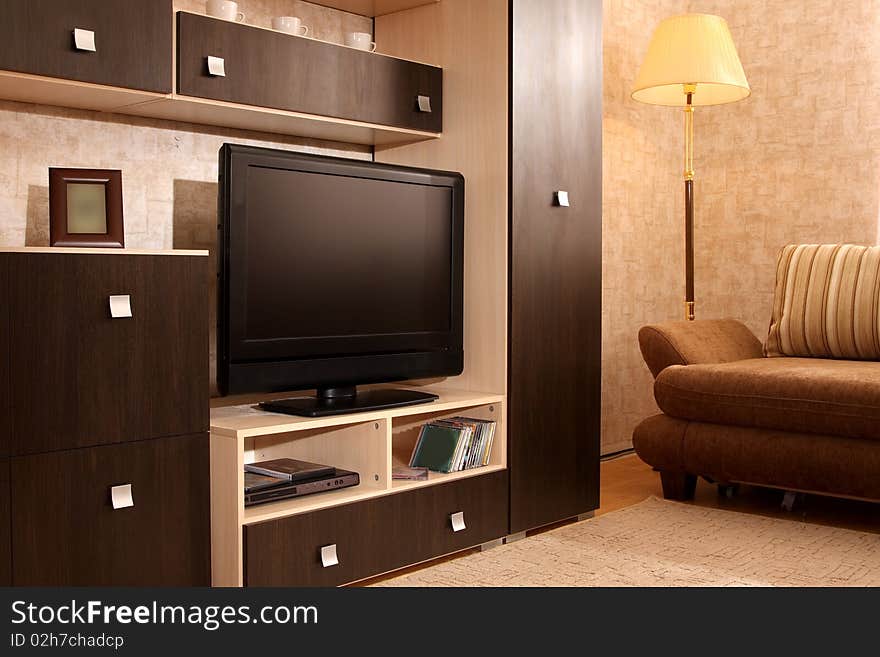 Interior of a living room with a window and different furniture