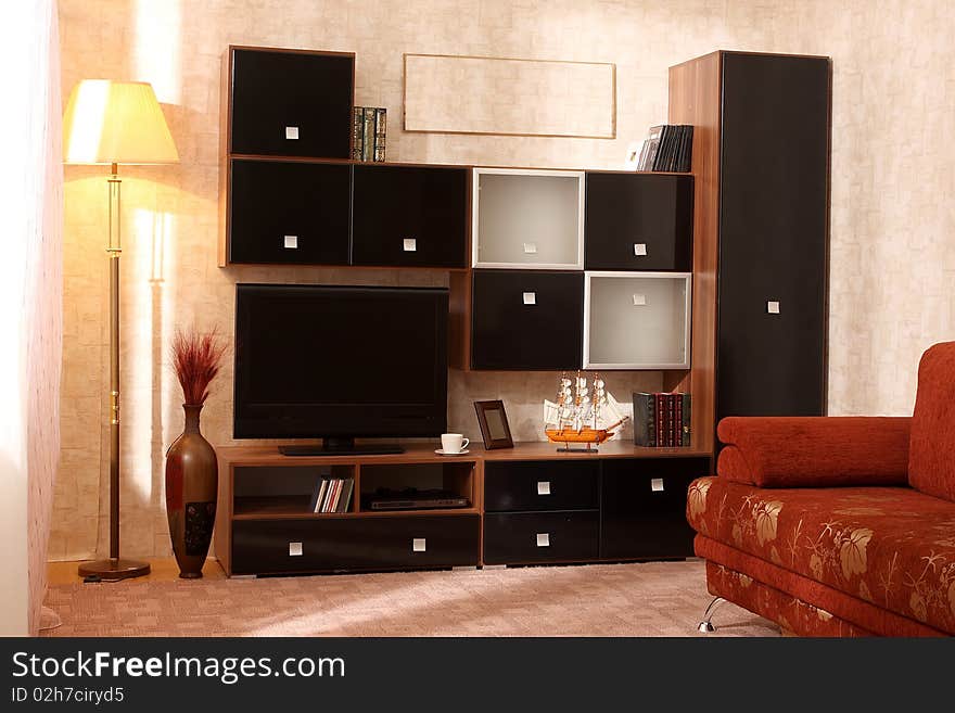 Interior of a living room with a window and different furniture