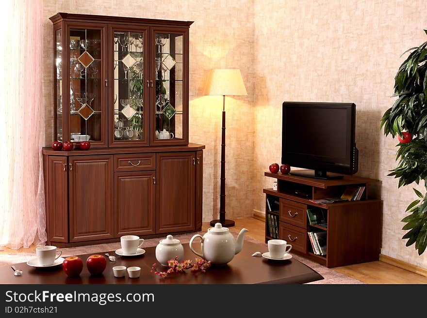 Interior of a living room with a window and different furniture