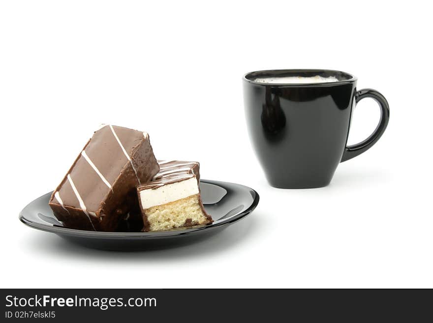 Three cookie in chocolate on black plate and cup of coffee isolated on white