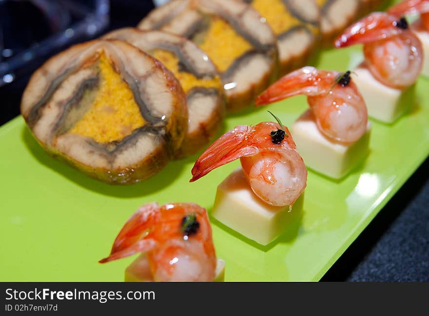 Tray of prawn appetizer with tofu and greens