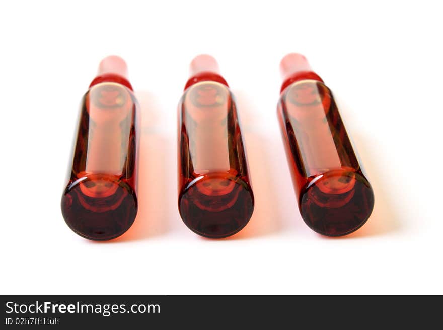 Red ampoules on a white background it is isolated