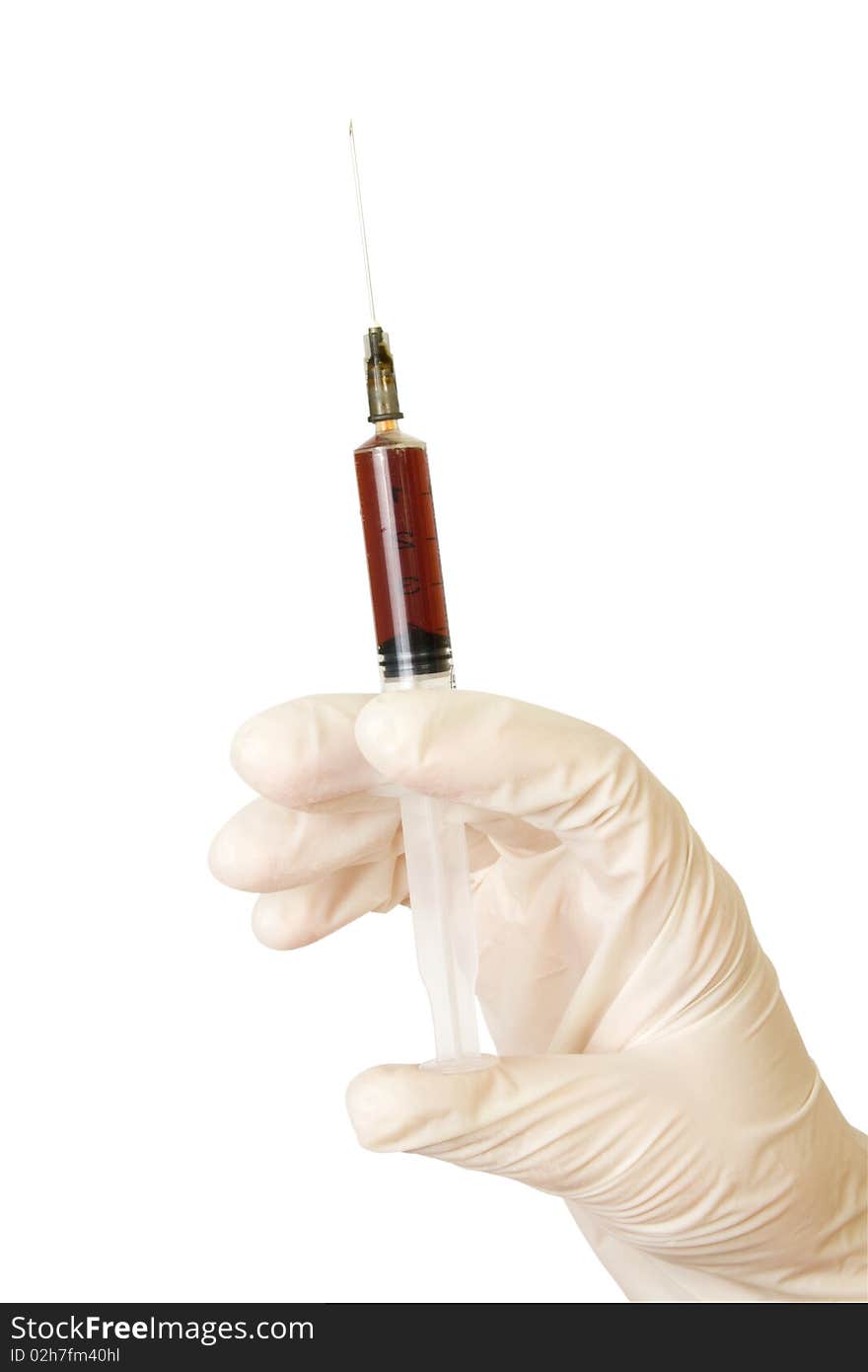 Hand with a syringe in a rubber glove it is isolated on white