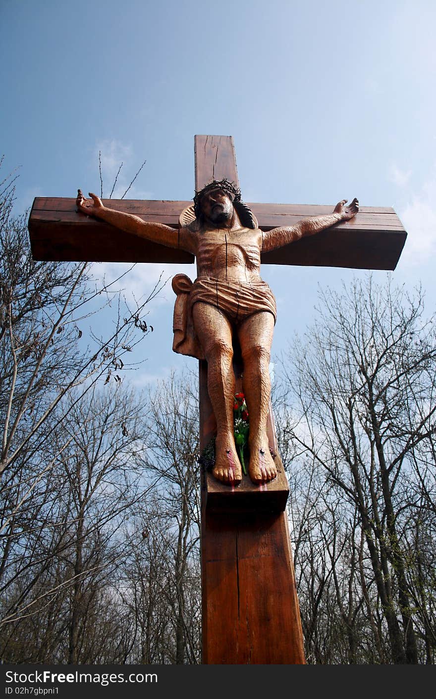 A wooden cross, a crucifix against the blue sky