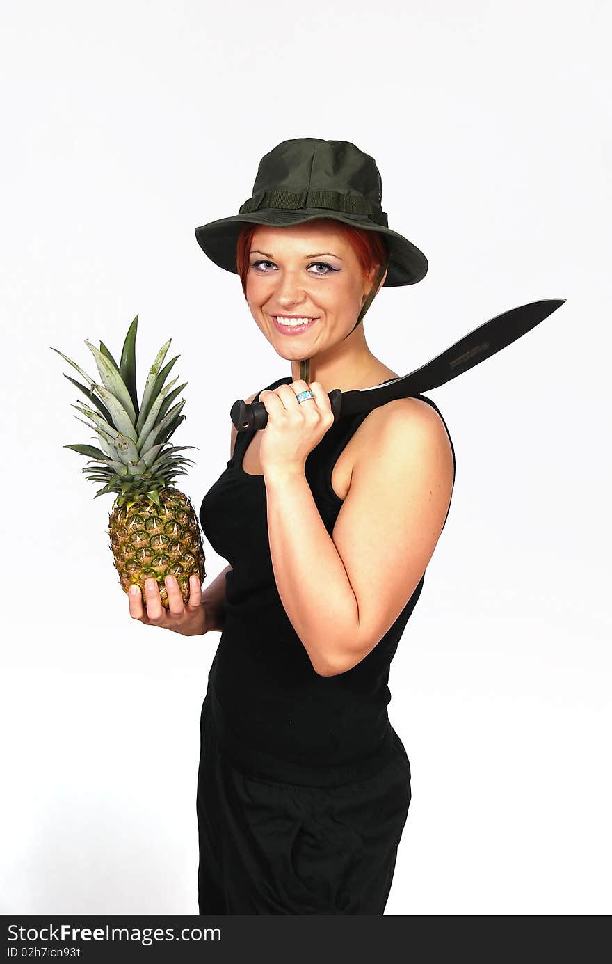 Smiling girl with the machete on the shoulder and with pineapple in the hand. Smiling girl with the machete on the shoulder and with pineapple in the hand