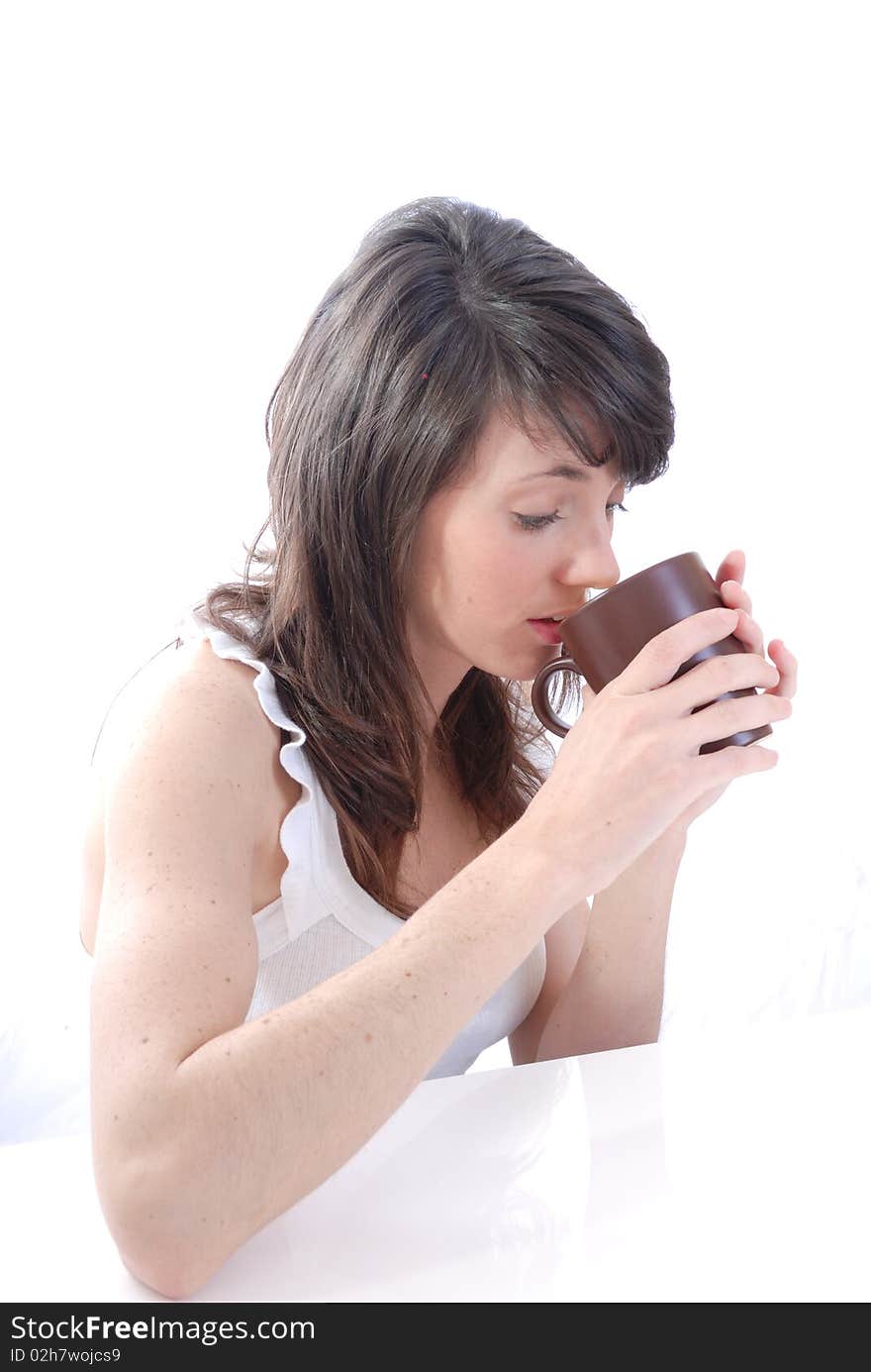 Photograph showing young female drinking from cup. Photograph showing young female drinking from cup