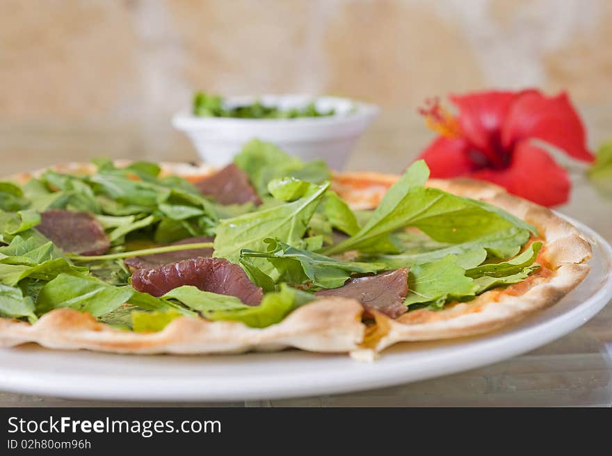 Beef pizza with salad topping