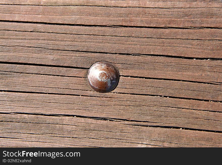 Wooden texture with a bolt