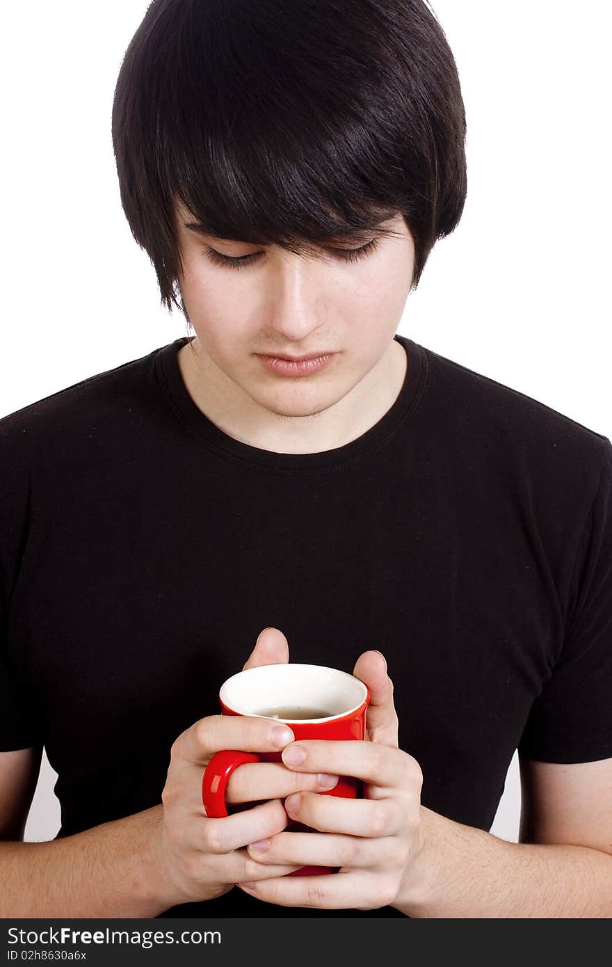 Sad boy with cup of tea/coffee isolated on white