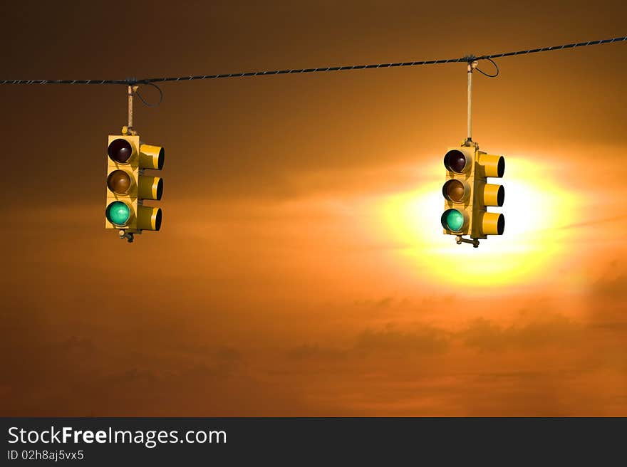 Traffic lights on green backed by a beautiful sunset. Traffic lights on green backed by a beautiful sunset.