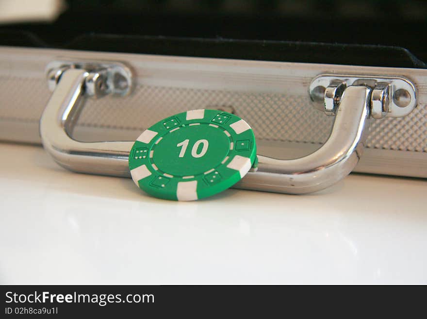 Focus on green casino chip with the value ten. Focus on green casino chip with the value ten