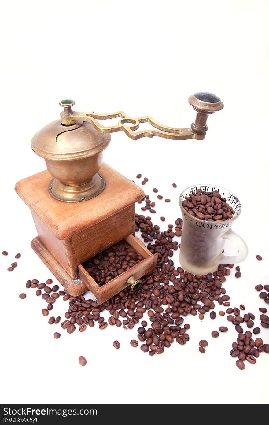 Old-fashioned coffee grinder and coffee beans