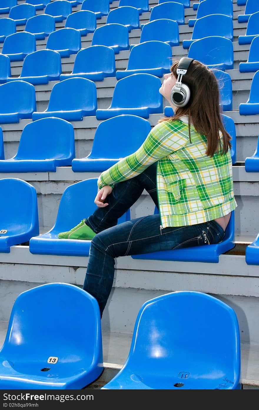 Teen at the stadium with earphones. Teen at the stadium with earphones