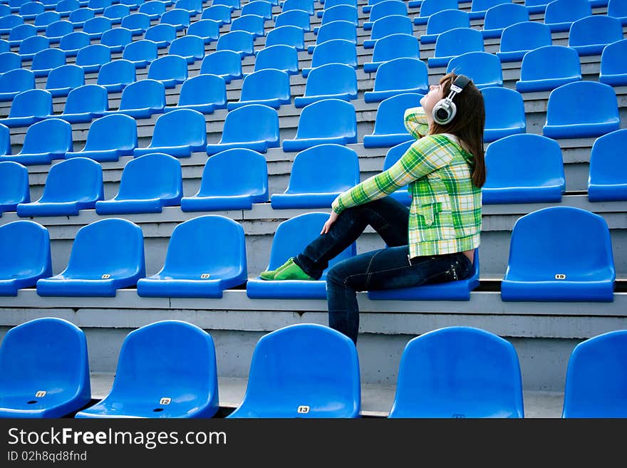 Teen at the stadium with earphones. Teen at the stadium with earphones