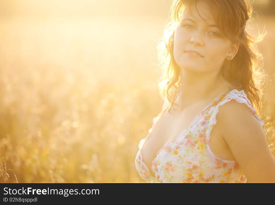 The young woman in a  dress in the field