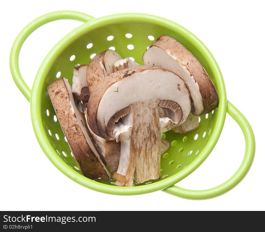 Fresh Mushroom Slices in a Vibrant Green Colander Isolated on White with a Clipping Path.