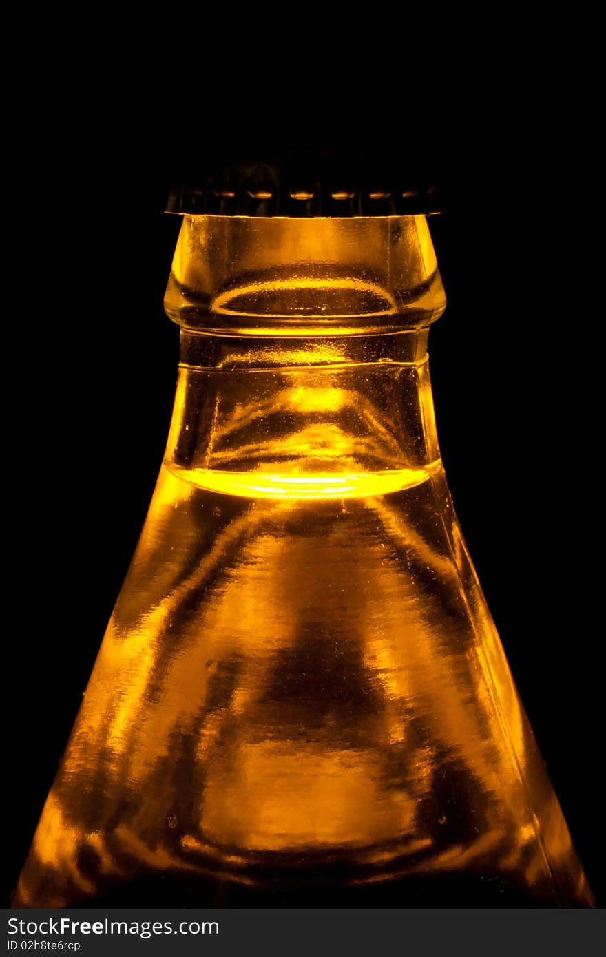 A beer bottle in a light on black