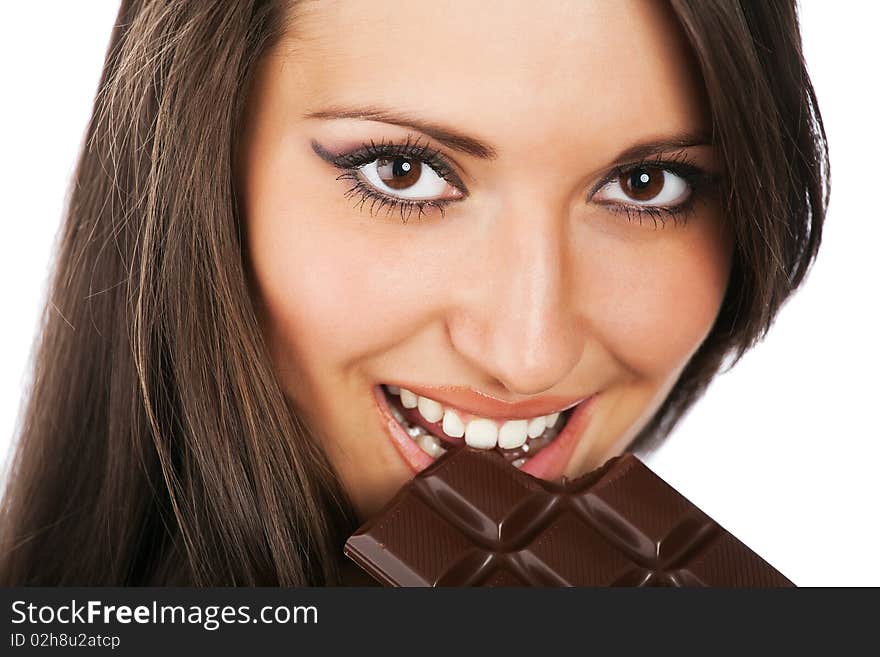 Portrait of young happy smiling woman eating chocolate