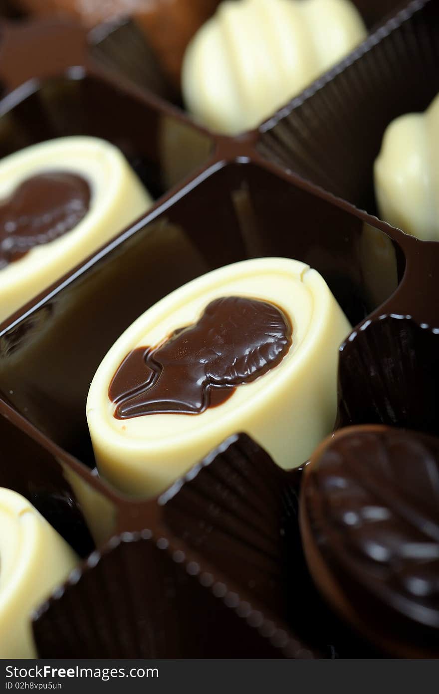 Delicious background of swiss dark chocolates, milk chocolates, pralines and truffles