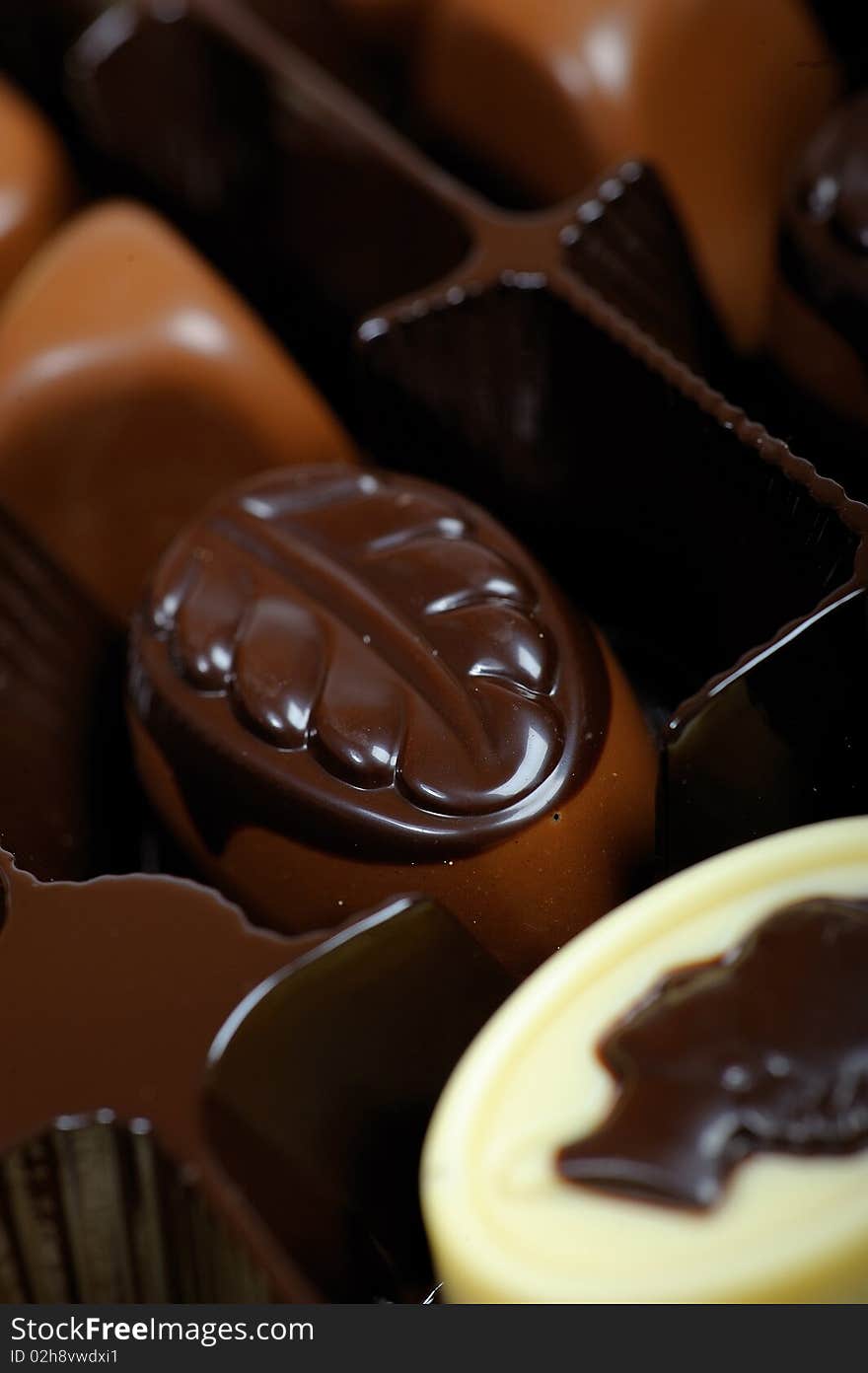 Delicious background of swiss dark chocolates, milk chocolates, pralines and truffles