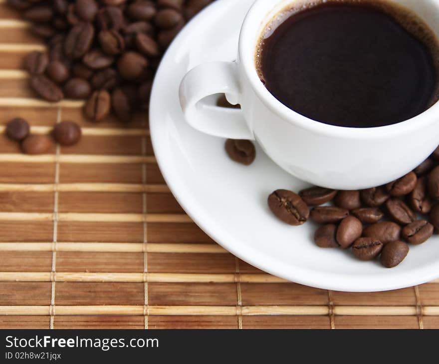 Cup of coffee on a background coffee grains