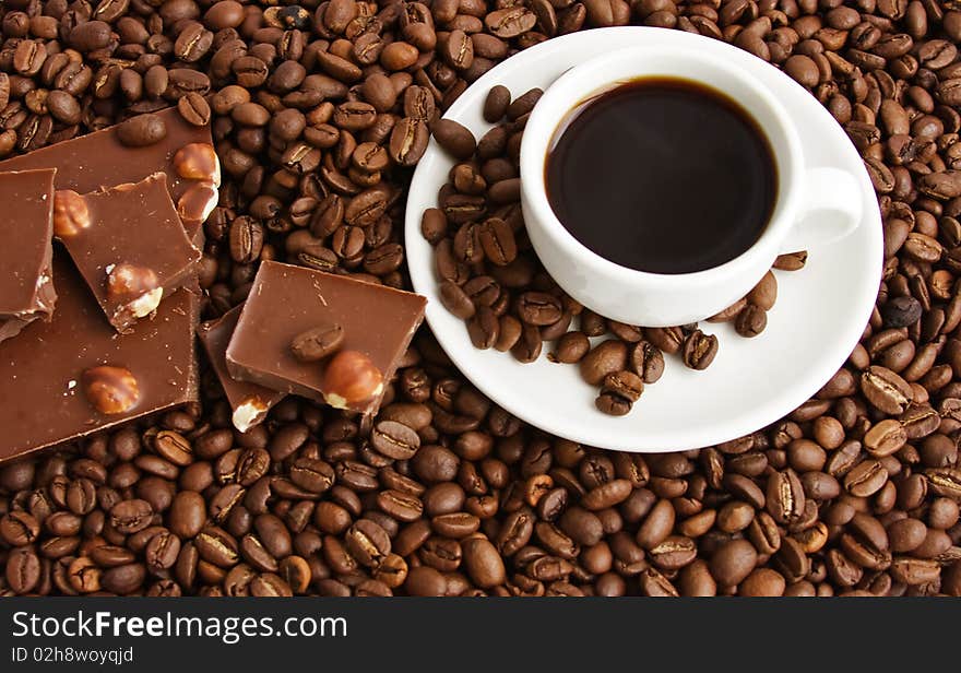 Cup of coffee on a background coffee grains