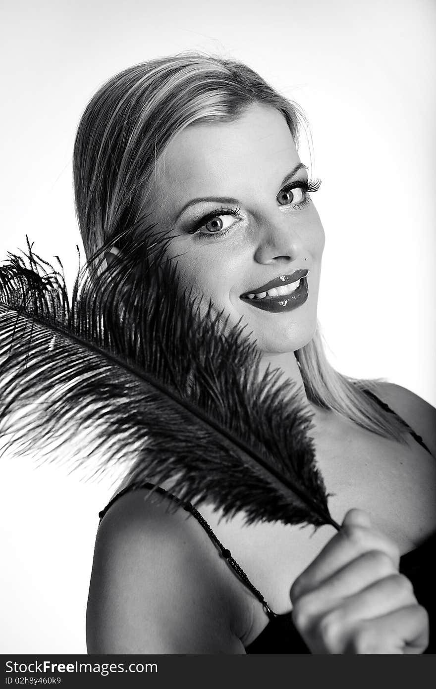 B/w Portrait of fashion woman with red lips in black dress with bird feather. white background. B/w Portrait of fashion woman with red lips in black dress with bird feather. white background