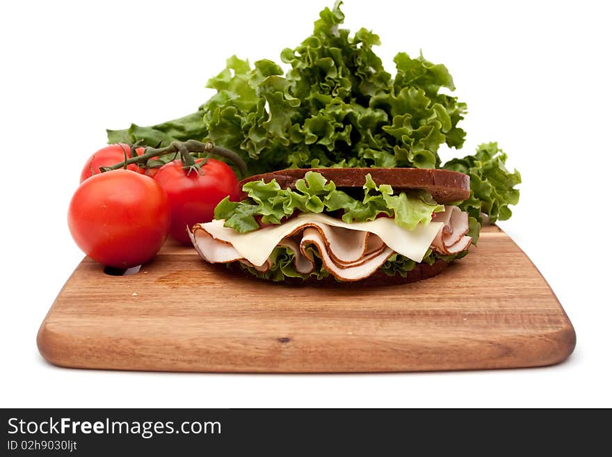 Healthy turkey breast sandwich on rye bread with vine ripe tomatoes and lettuce on white background. Healthy turkey breast sandwich on rye bread with vine ripe tomatoes and lettuce on white background