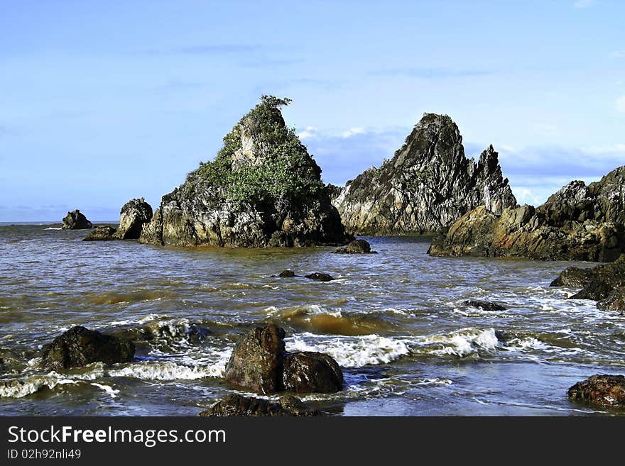 Rock at the edge of the tropical sea coast, north of Java, Indonesia.