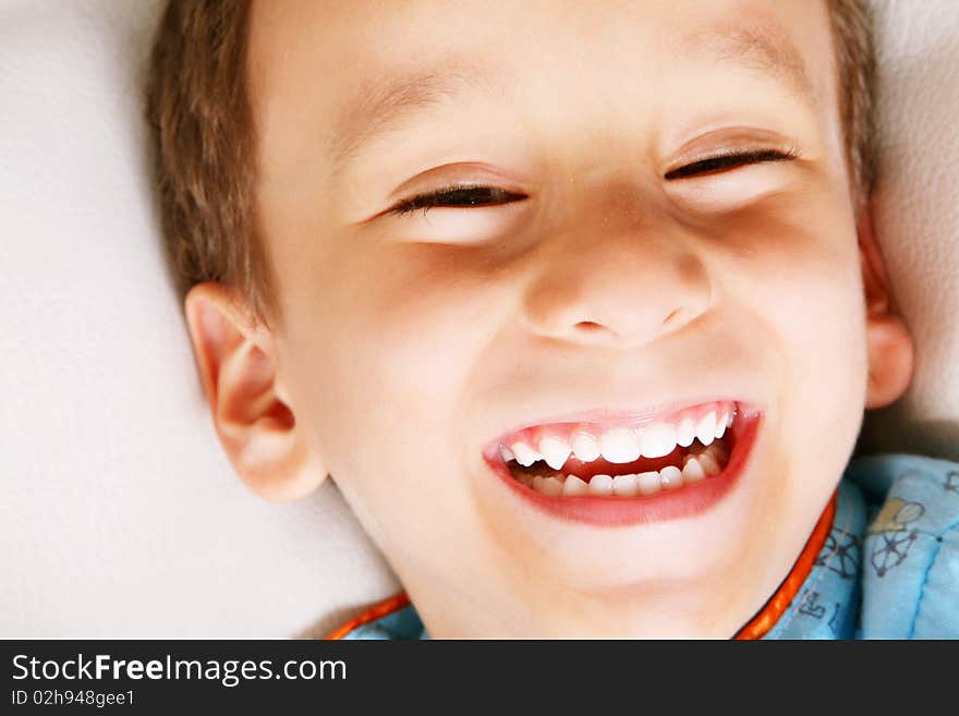 Four years old boy laughing over white background. Happiness concept. Four years old boy laughing over white background. Happiness concept