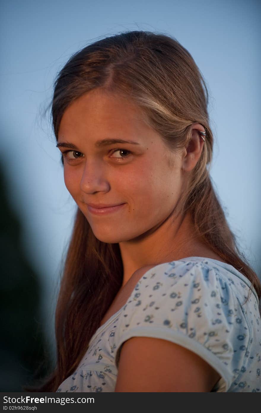 Pretty teen girl in evening light looking at camera. Pretty teen girl in evening light looking at camera