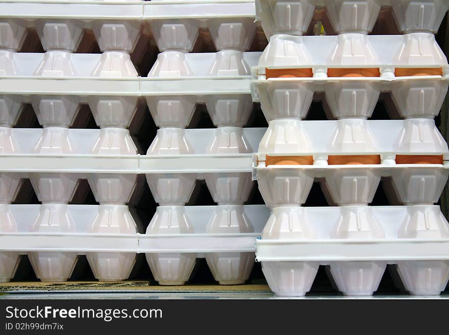 White cartons of eggs in column. White cartons of eggs in column