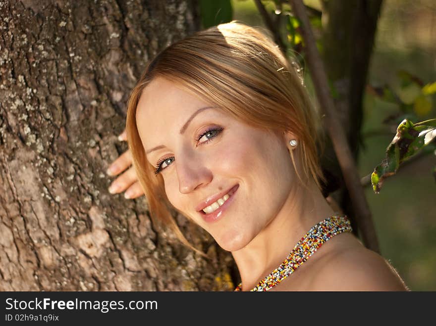 Pregnant woman on a grass and smiling