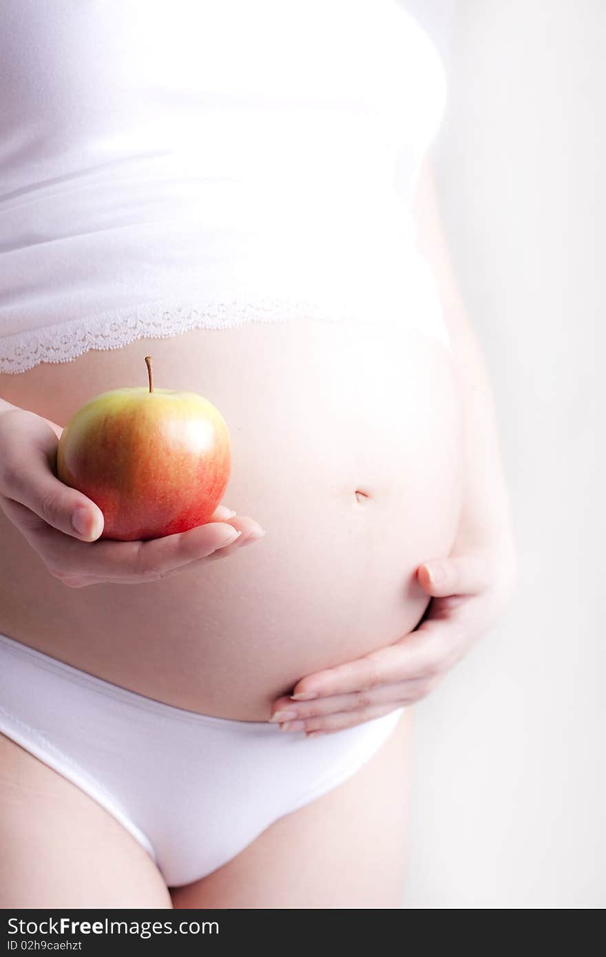 A pregnant woman posing for a photo session. A pregnant woman posing for a photo session