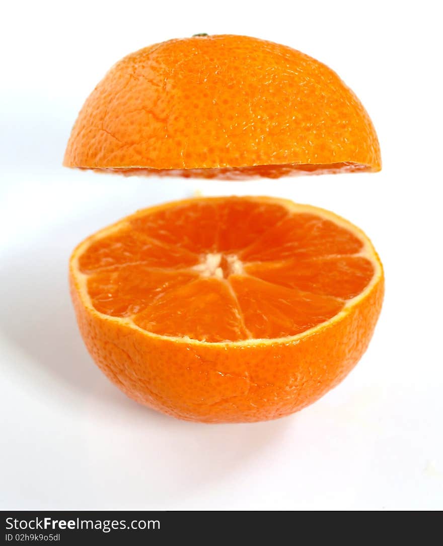 A clementine that has been cut in half and separated. A clementine that has been cut in half and separated.