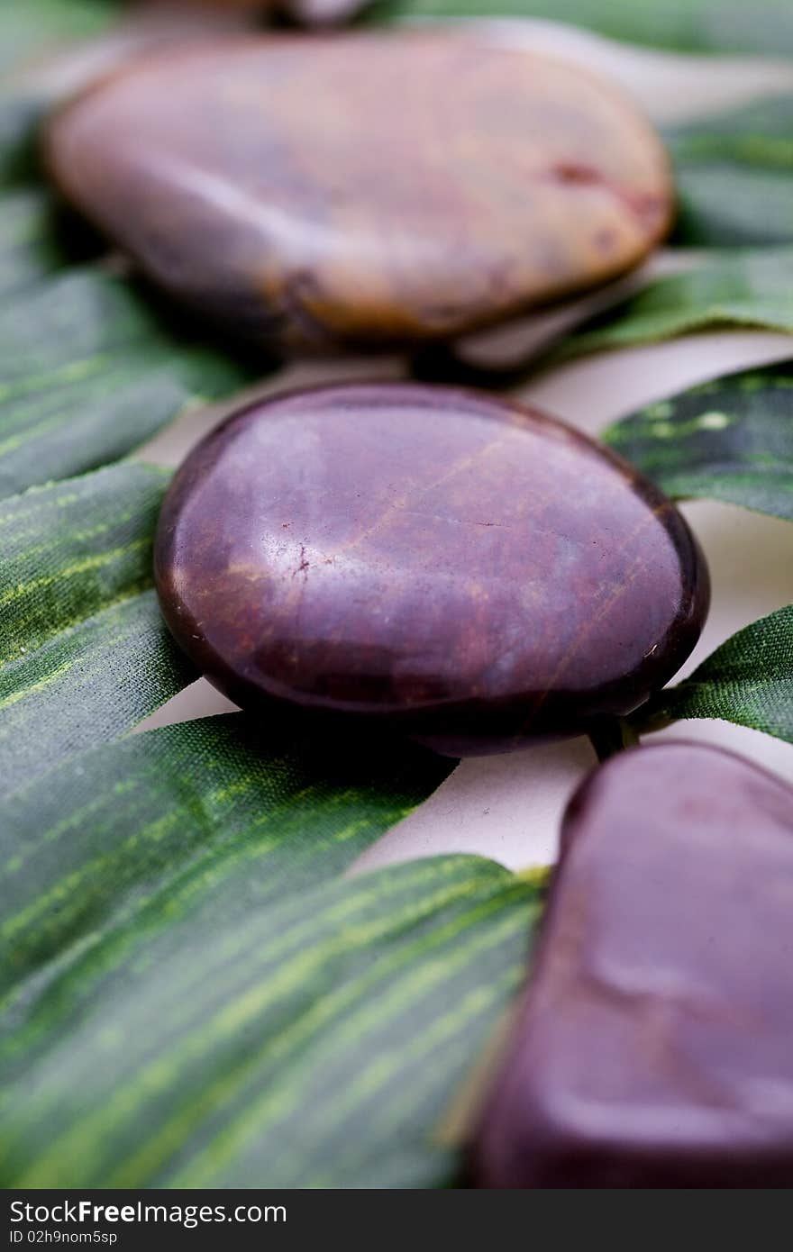 Stones on green leaf for relaxing and peace.