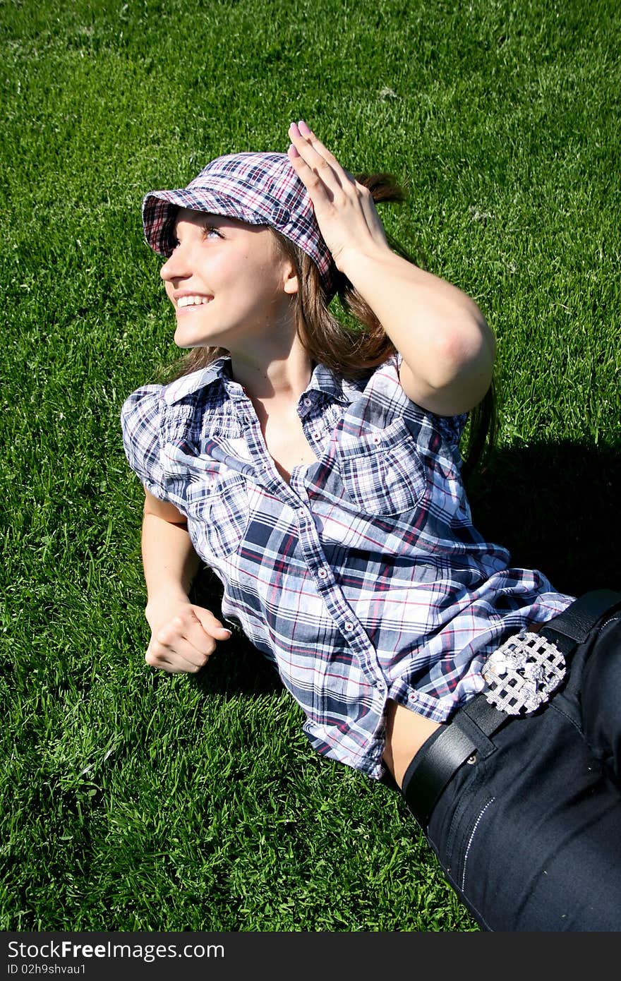 Young girl on the green grass