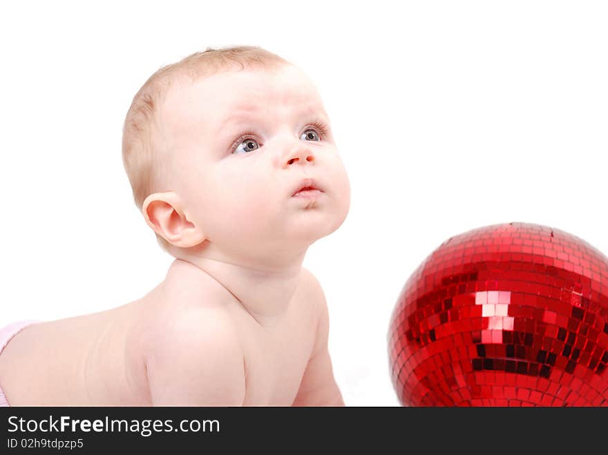 Baby on white playing with a red Christmas ornament. Baby on white playing with a red Christmas ornament.