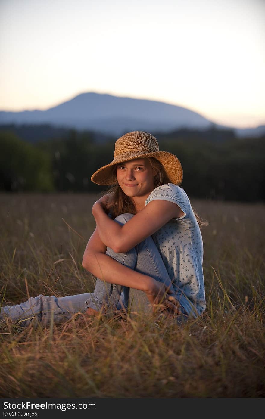 Teenage girl sitting in a field