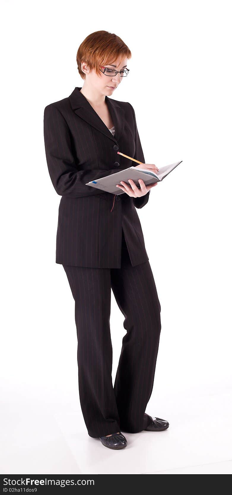 White woman in black suit standing isolated on white background. White woman in black suit standing isolated on white background