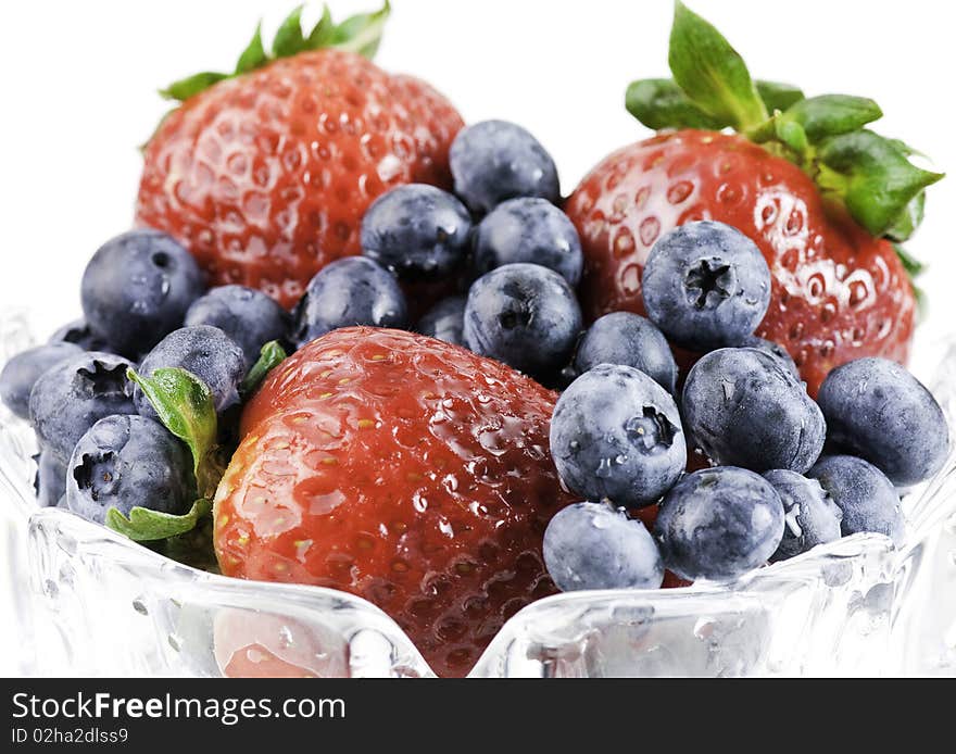 A bowl of strawberries and blueberries. A bowl of strawberries and blueberries