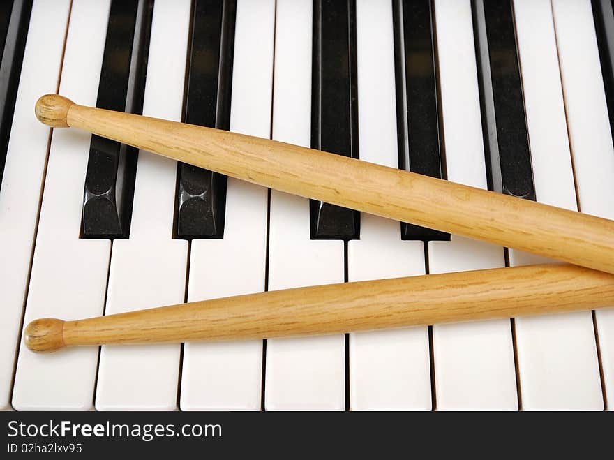 Drum sticks on piano keyboard