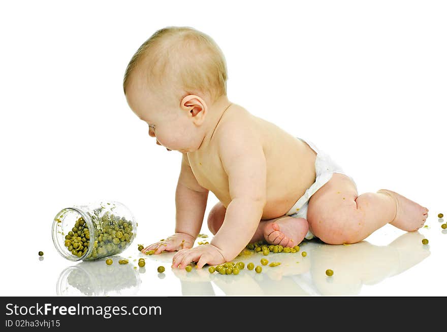 Playing six month baby with jar of pea  on white. Playing six month baby with jar of pea  on white