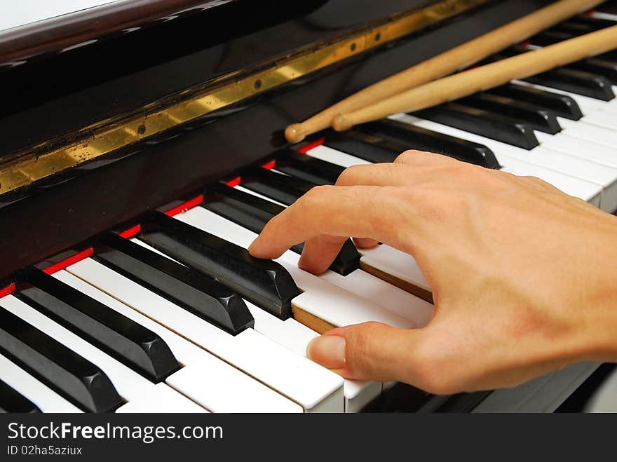 Right hand playing on piano keyboard