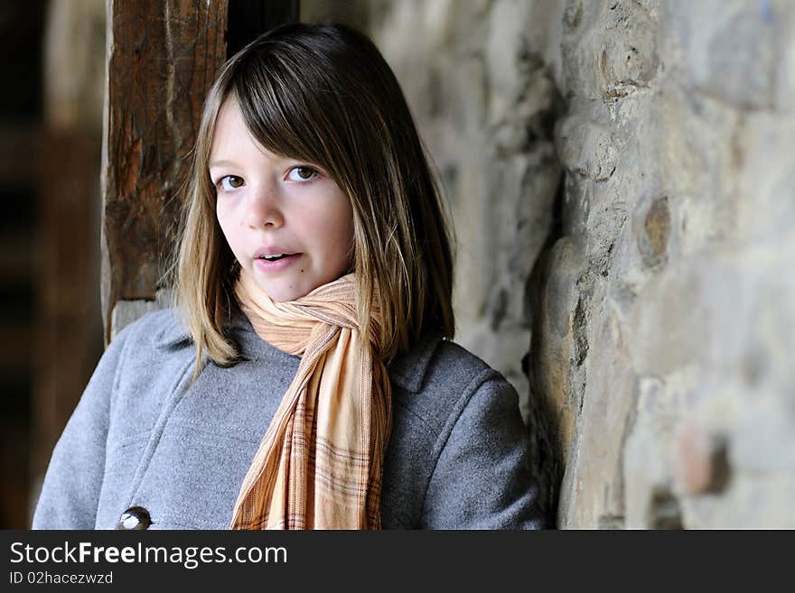 Beautiful girl posing with old wall in background