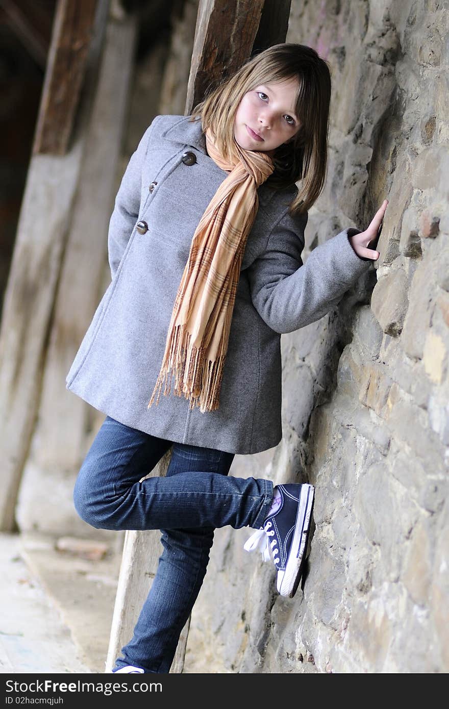 Beautiful Girl Posing With Old Wall In Background