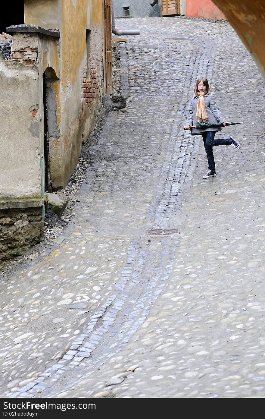 Young model posing with object in old city. Young model posing with object in old city