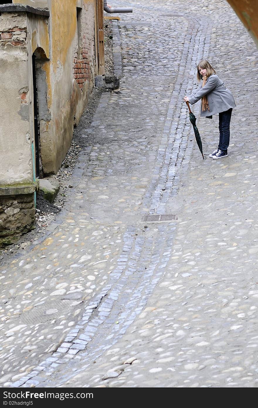 Young model posing with object in old city. Young model posing with object in old city