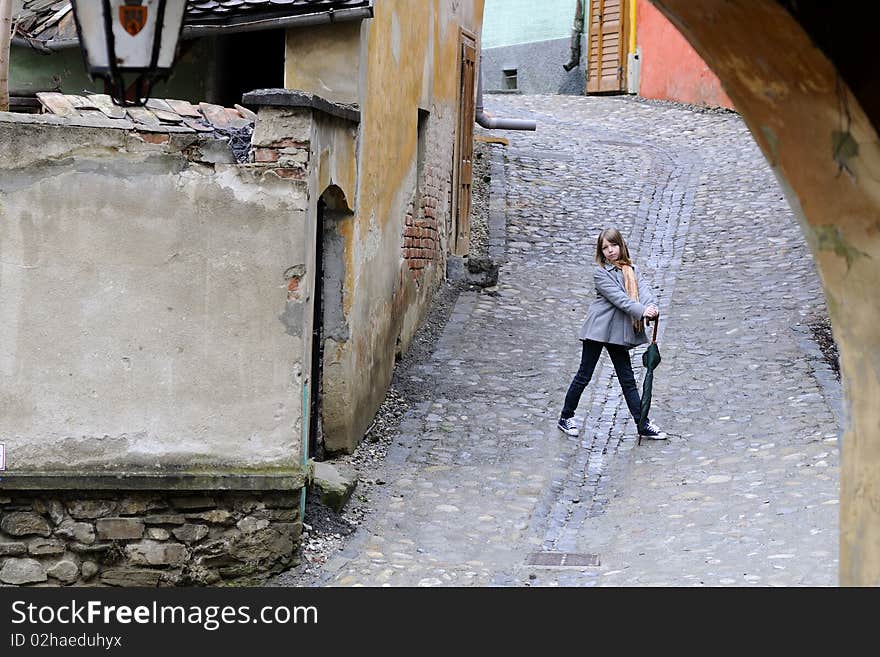 Young model posing with object in old city. Young model posing with object in old city